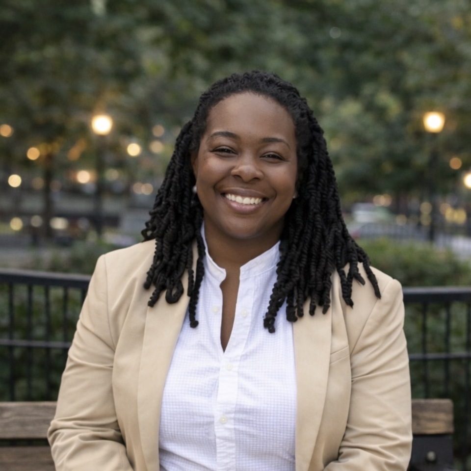 Head-and-shoulders portrait of Kendra Simms in a tan blazer